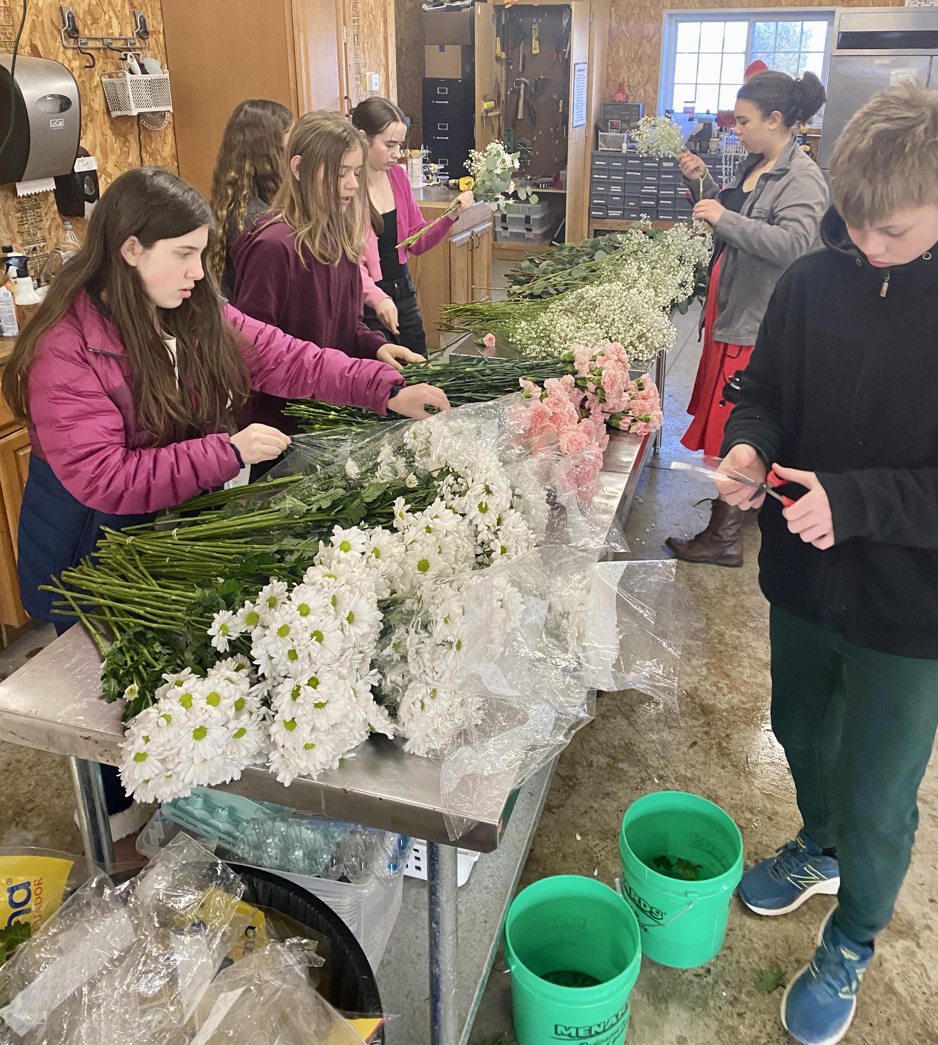 students preparing flower bouquets